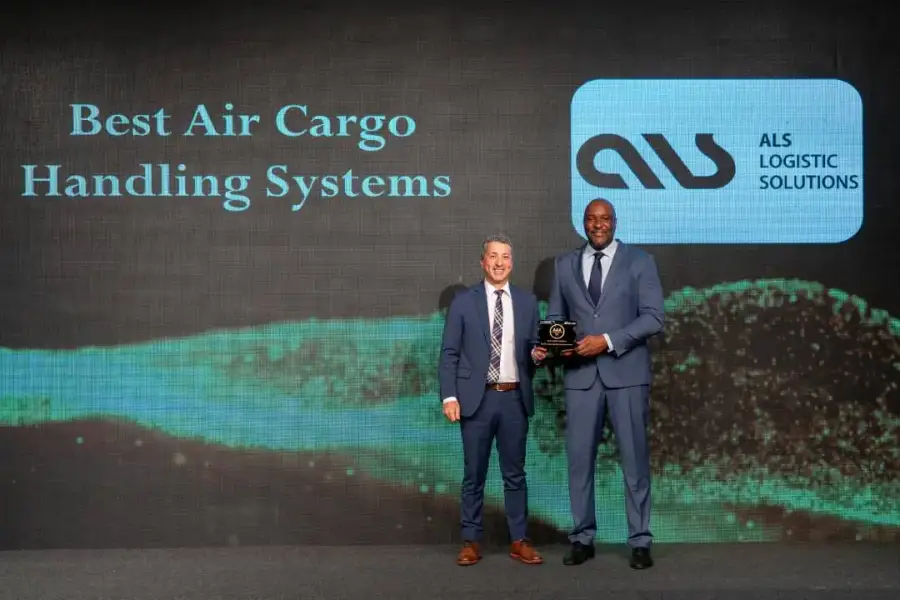 ALS team holding the Best Air Cargo Handling Systems plaque beside the ALS logo at the Aviation Achievement Awards 2022